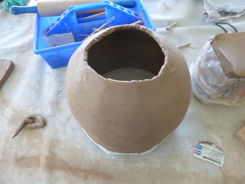 Curving in the top to form the outer bell