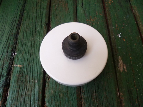 The bottom push-on cap with tap fitting in place