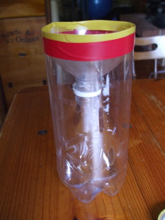 Bottle with funnel inserted and secured