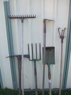 L-R Mattock, rake, fork, hoe, spade, 3 tine cultivator 