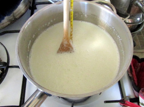 stirring with wooden spoon and thermometer